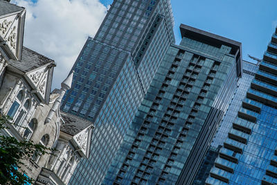 Low angle view of modern buildings against sky in city