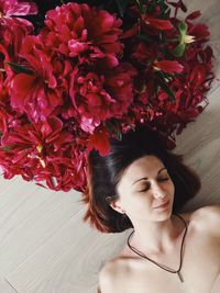 Portrait of woman with red flowers