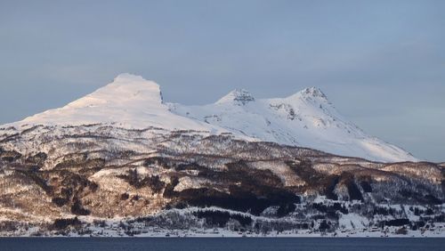 Scenic view of snowcapped mountains against sky