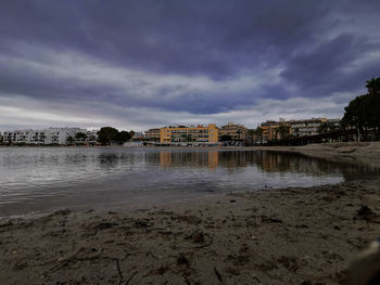 Buildings by sea against sky in city