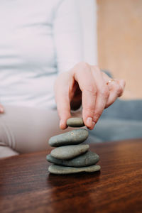 A woman collects a cairn, the concept of calmness and meditation.