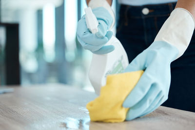 Cropped hand of woman with iv drip on table