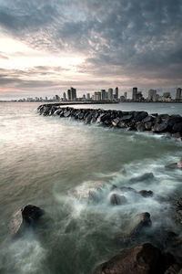 Scenic view of sea against cloudy sky