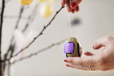 Woman's hands hanging easter decoration