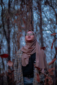 Woman standing against trees during autumn