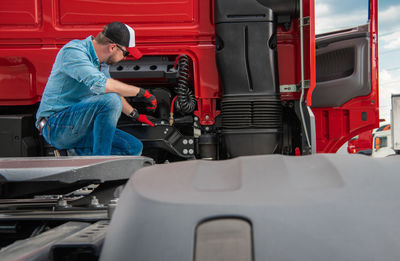 Trucker examining truck