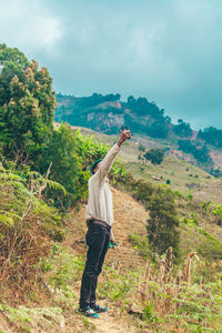 Rear view of man standing on mountain