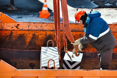 Midsection of man working in boat