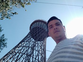 Low angle view of man against clear sky