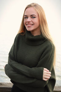 Portrait of young woman standing on snow