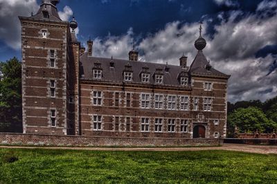 Facade of building against cloudy sky