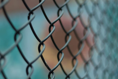 Close-up of chainlink fence against sky