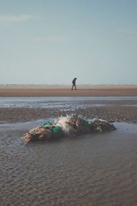 Man on beach against sky