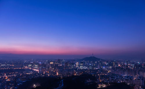 High angle view of city lit up at night