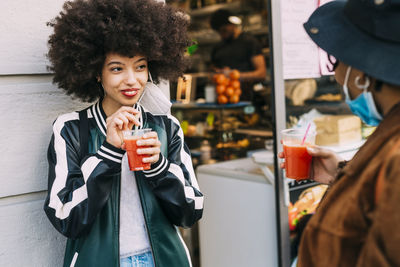 Portrait of a beautiful young woman drinking drink