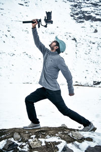 Full length of man standing on snow