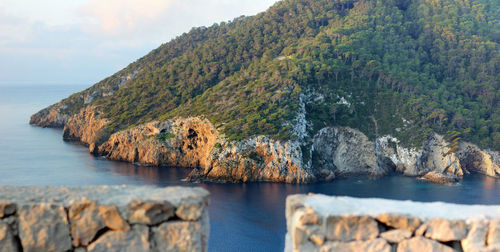 Idyllic coast of balearic island ibiza with steep cliffs and overgrown hills