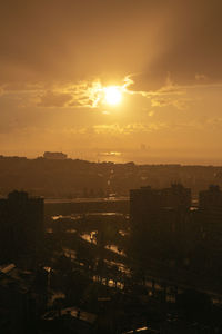High angle view of illuminated cityscape against sky during sunset