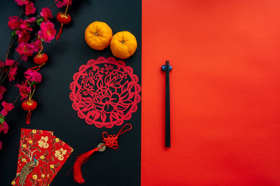Chinese lunar new year decoration over red and black background. flat lay dinning table concept.