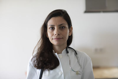 Female doctor with pen and coat in a practice