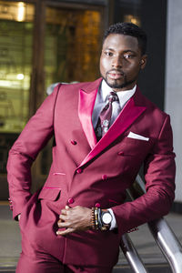 Portrait of young man standing at home