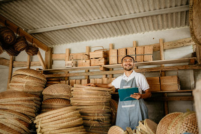 Rear view of man working at market