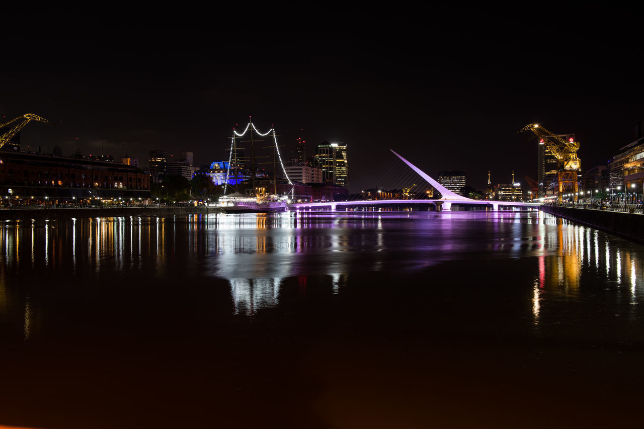 ILLUMINATED BRIDGE OVER RIVER