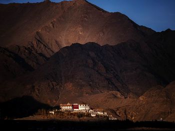 Scenic view of mountains and houses against sky