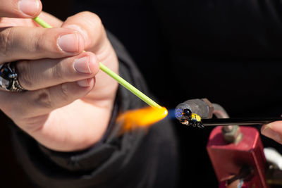 Close-up of hand sculpting while using blow torch