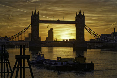 Sun rises behind tower bridge