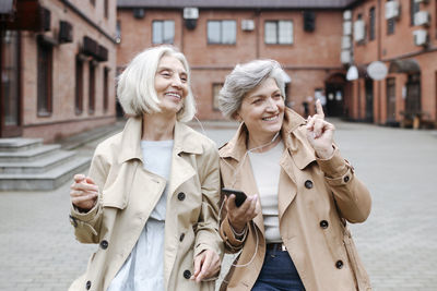 Portrait of smiling young woman on street in city