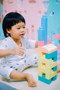 Cute girl playing with plastic toys