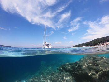 Sailboat in sea against sky