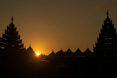 Silhouette of temple against sky during sunset