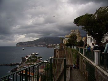 Pier on sea against cloudy sky