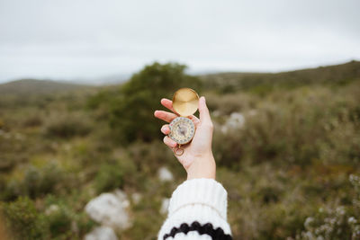 Midsection of person holding plant