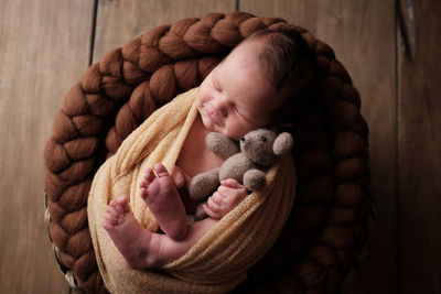 Portrait of cute baby sleeping in toy