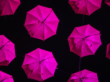 Low angle view of multi colored umbrellas hanging on paper