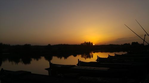 Scenic view of lake against orange sky