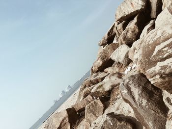 Low angle view of rock formation against sky