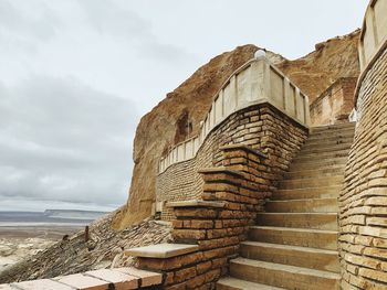 Low angle view of old building against cloudy sky