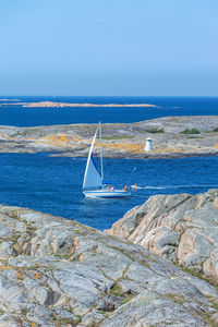 Sailboat sailing on sea against sky