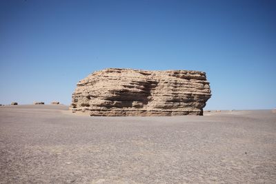 Rock formations in desert against clear blue sky