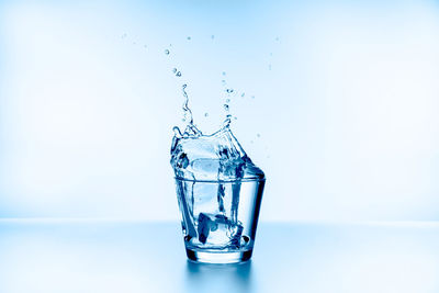 Close-up of water splashing against blue background