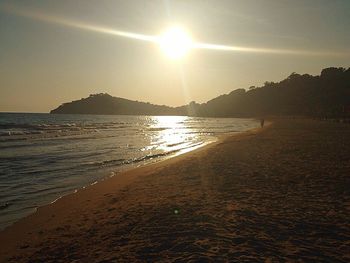 Scenic view of beach against sky during sunset