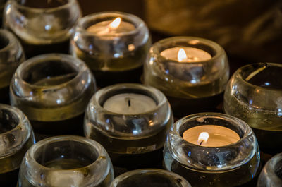 Close-up of lit candles in temple