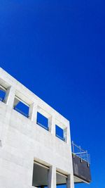 Low angle view of building against clear blue sky