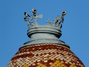 Low angle view of statue against clear blue sky