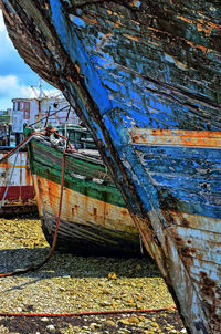 Abandoned boat moored at sea against sky