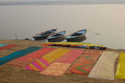 Multi colored umbrellas on beach against sky